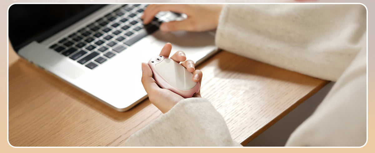 Bear hand warmer held at a desk