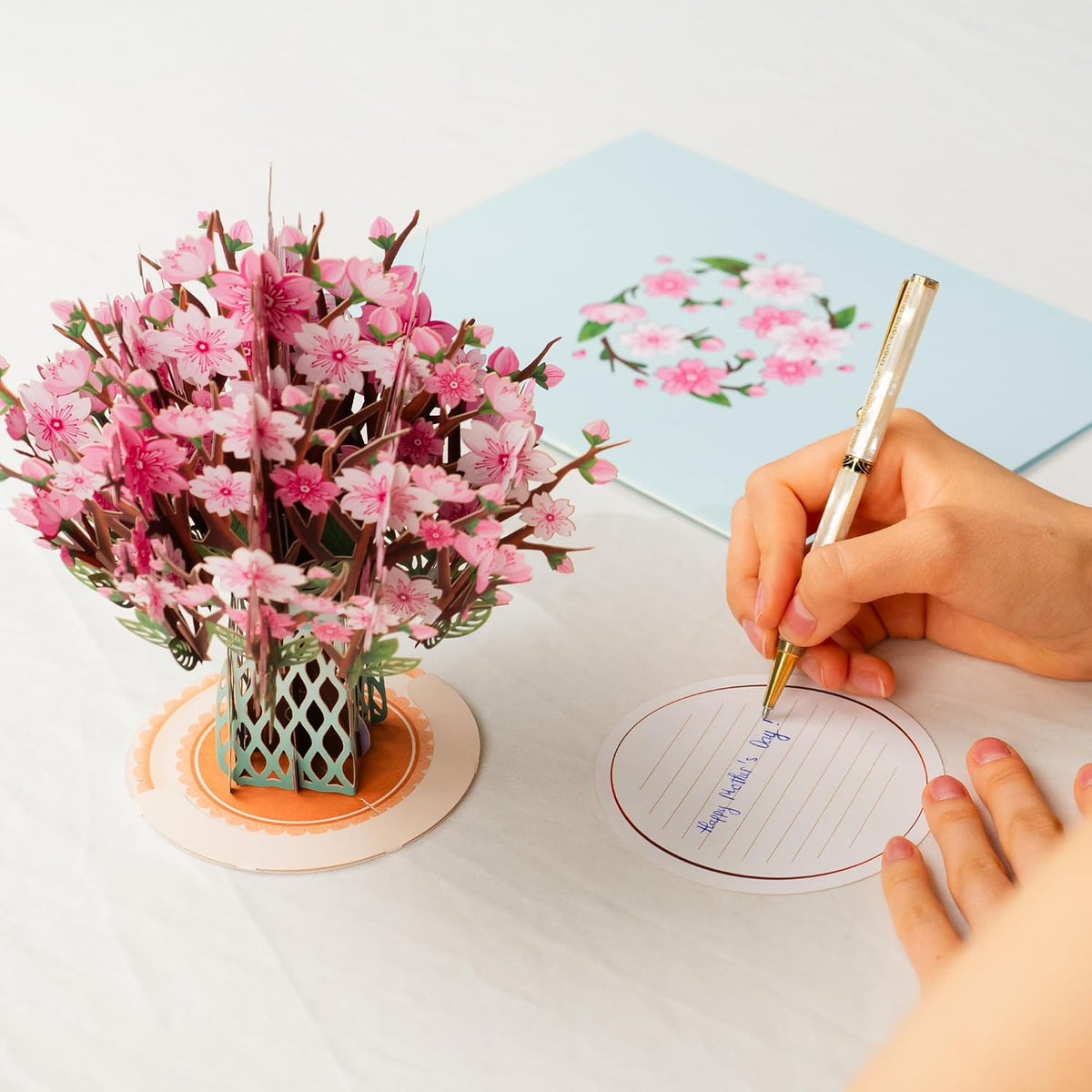 Handwritten removable note tag beside the paper bouquet