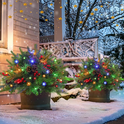 Two lighted Christmas urn fillers arranged on a porch