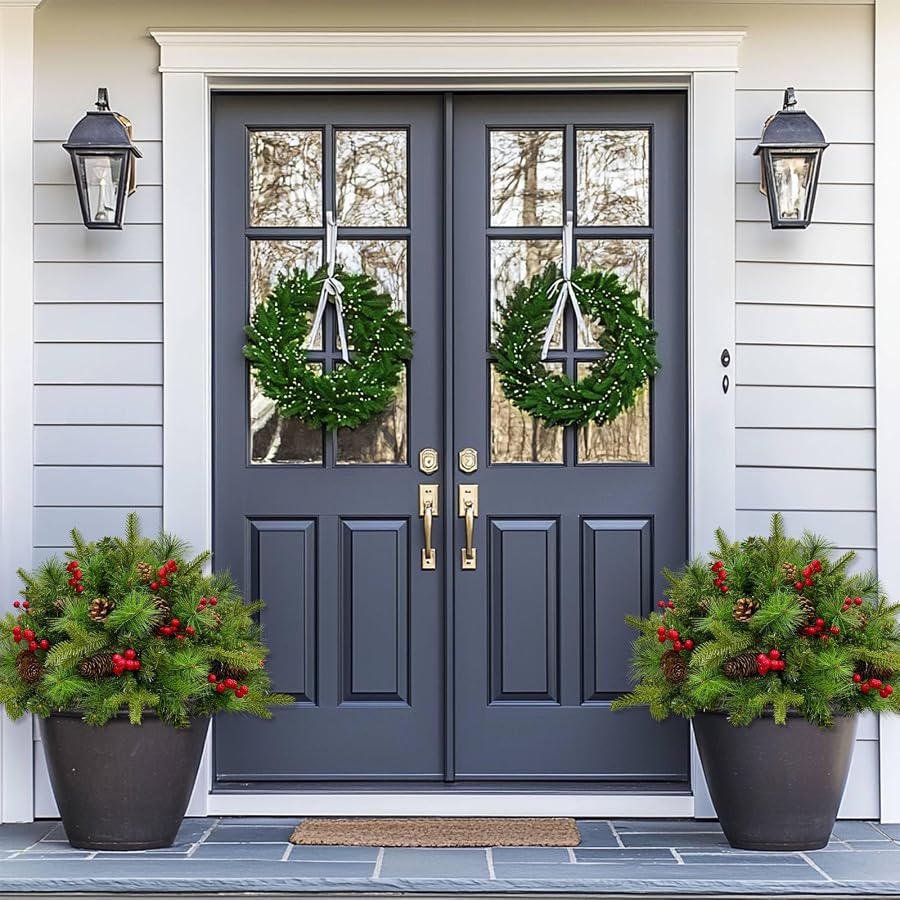 Two Christmas urn fillers styled beside a doorway; planters not included