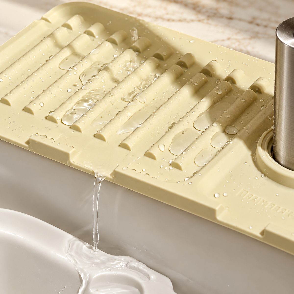 Faucet splash guard — water draining toward the sink