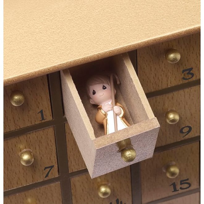 A Nativity figurine revealed inside a numbered wooden drawer