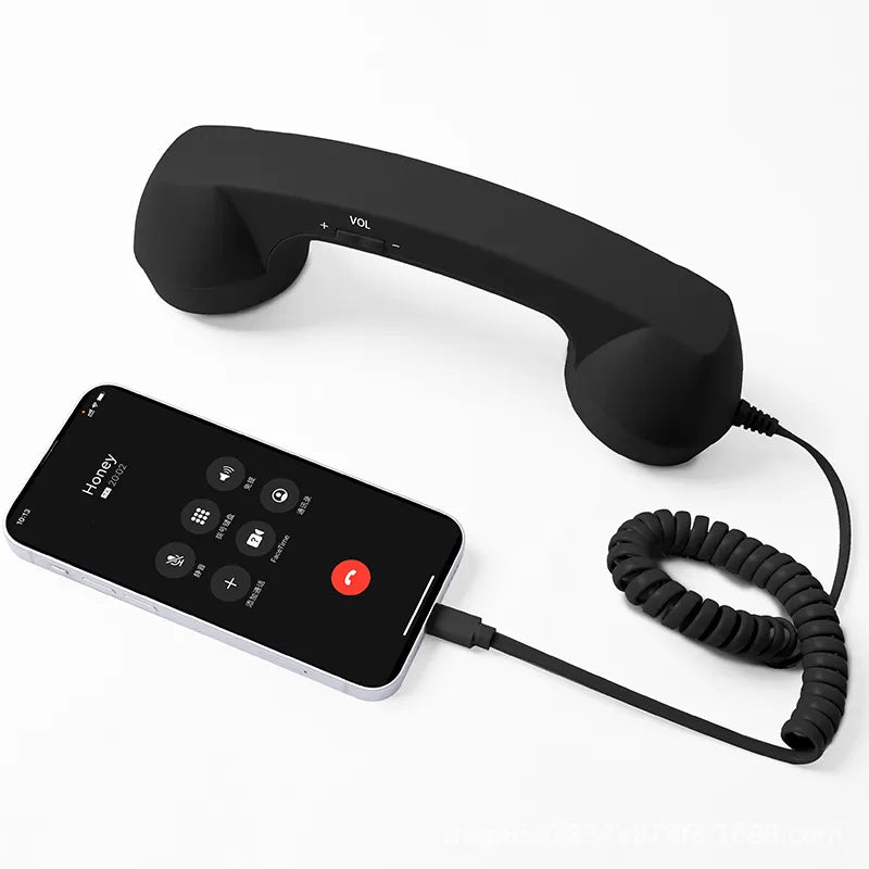 Black retro handset with coiled cord and smartphone
