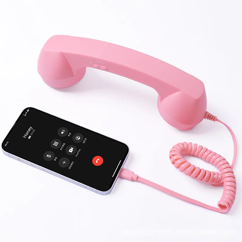 Pink retro handset with coiled cord and smartphone