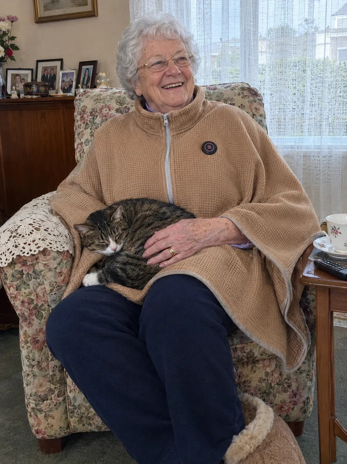 Warm Beige heated shawl worn while seated with a cat