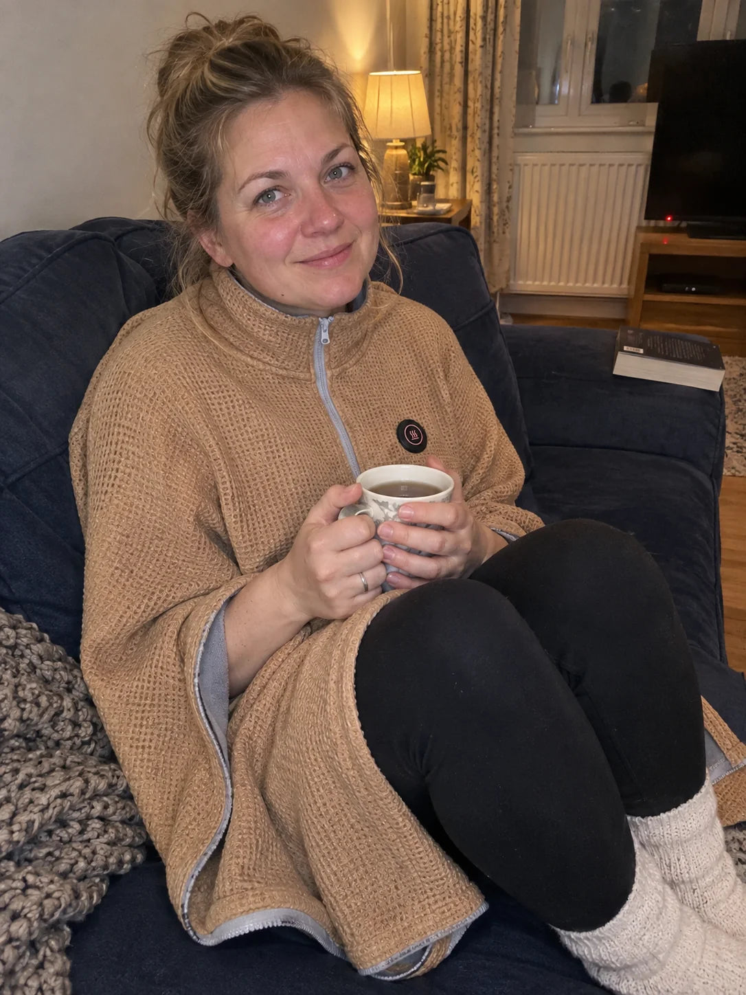 Warm Beige heated shawl worn while relaxing with a drink