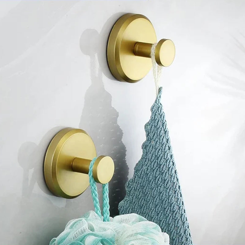 Gold suction hooks holding bathroom accessories