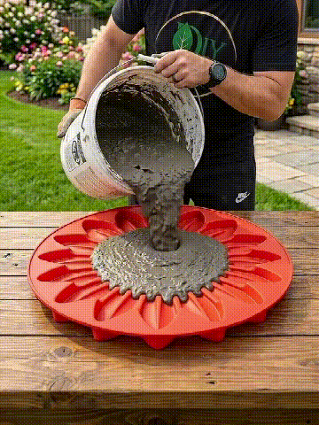Animated demonstration of pouring concrete into the red sunflower mold