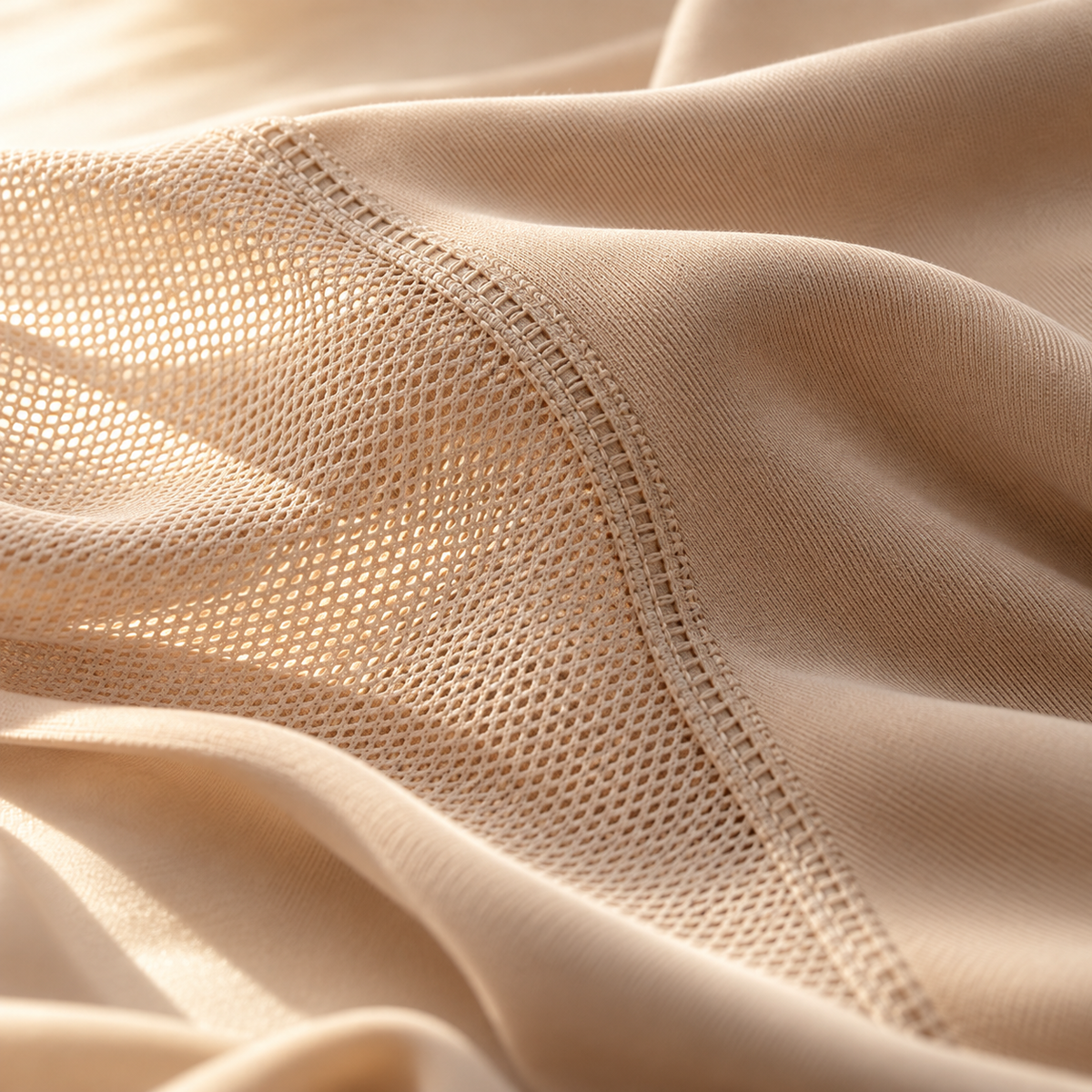Illustrative close-up of beige mesh and stretch fabric with fine stitching
